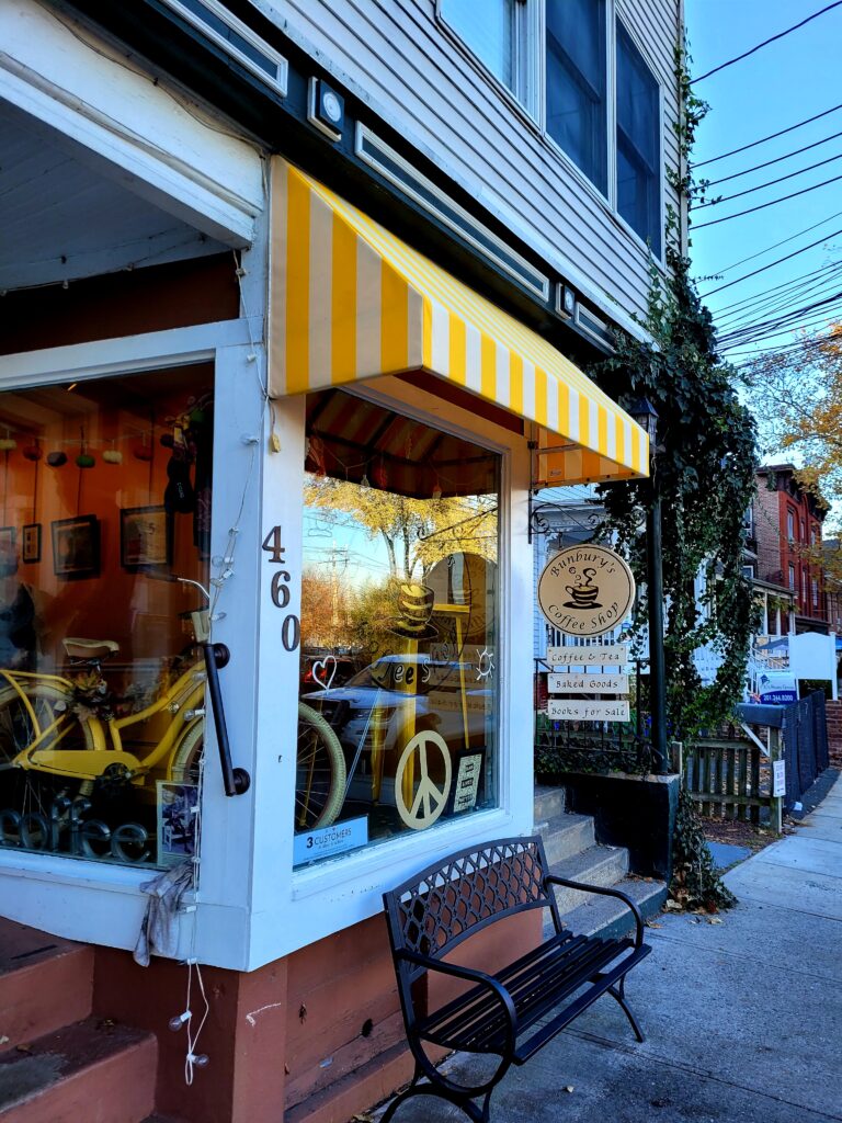 Charming small business storefront with yellow-and-white striped awning at Bunbury’s Coffee Shop in Piermont, NY, installed by Window Works NJ.